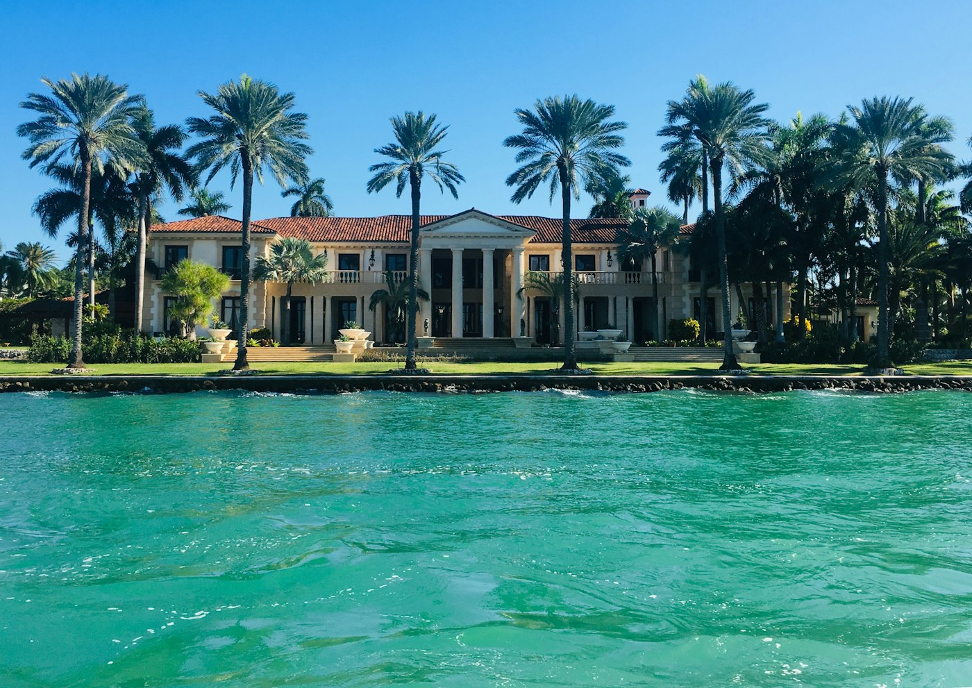Waterfront mansion with palms